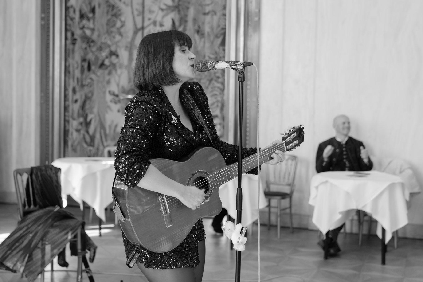 Sängerin mit Gitarre am Mikrofon